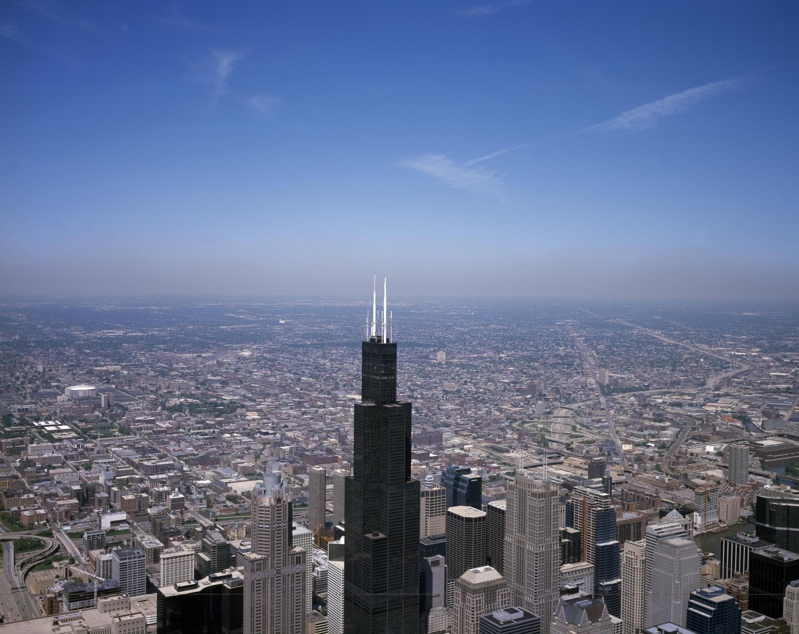 An aerial view compresses the 1990 skyline into a dense grid around Sears Tower.