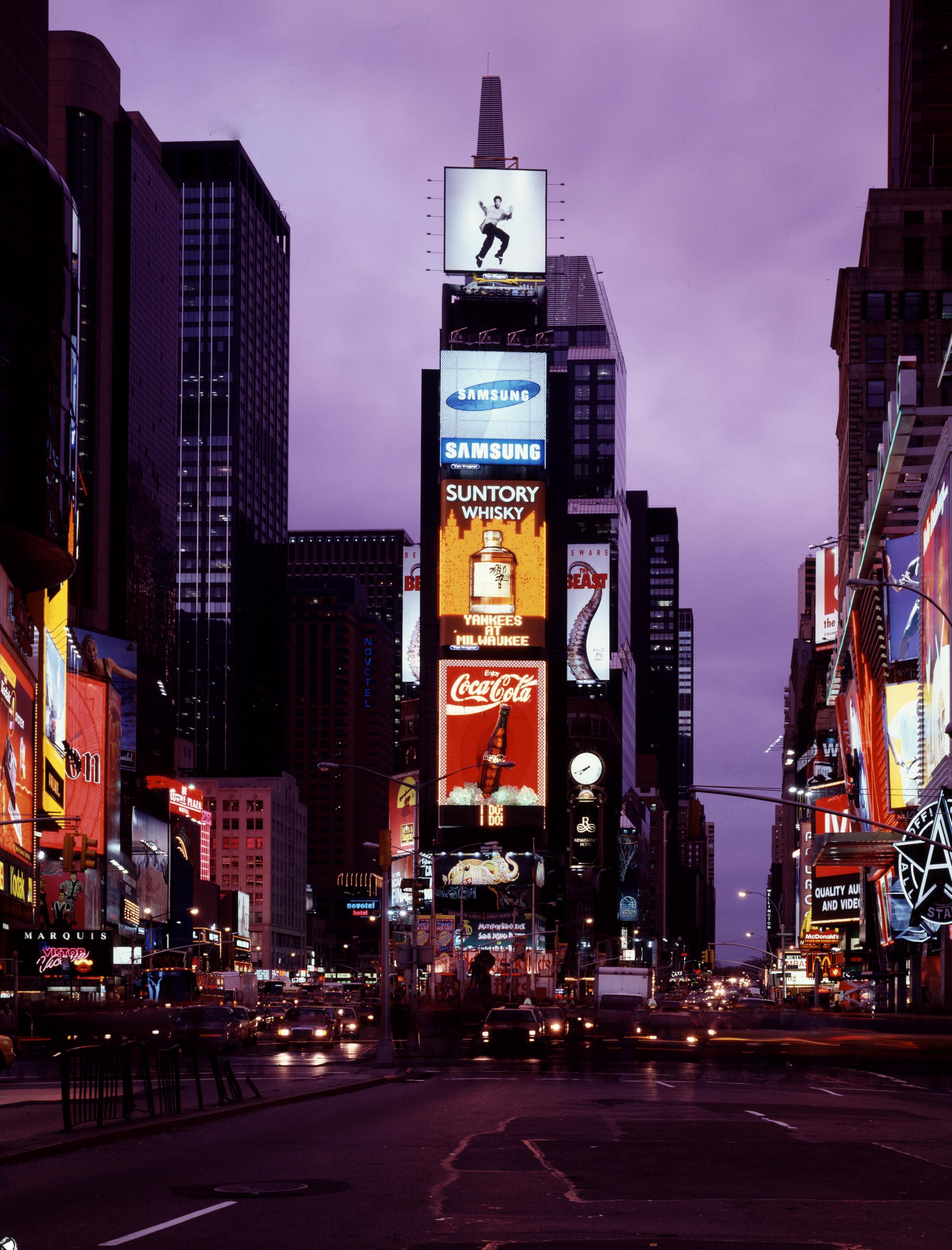 The crossroads of the world glows with marquees, traffic, and mid-1990s street life.