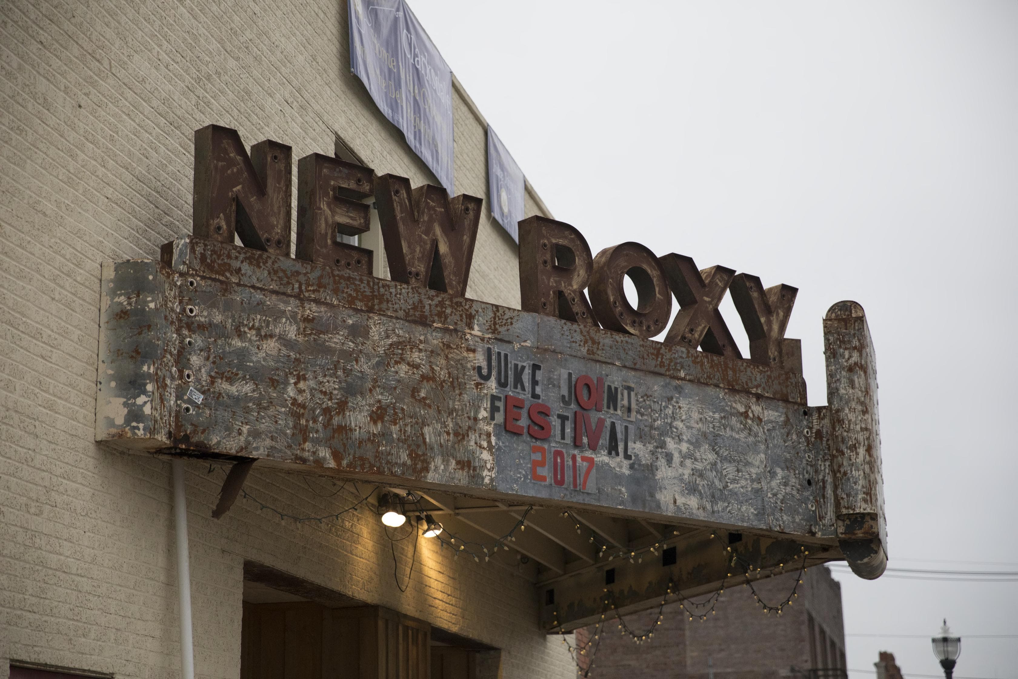 A vintage theater marquee welcomes festival-goers to Clarksdale, Mississippi.