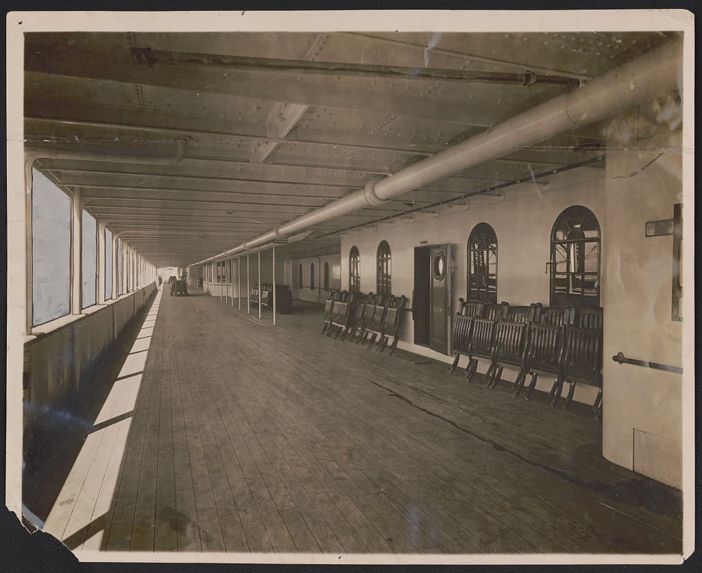 The great promenade deck of the Titanic, lined with windows and deck chairs