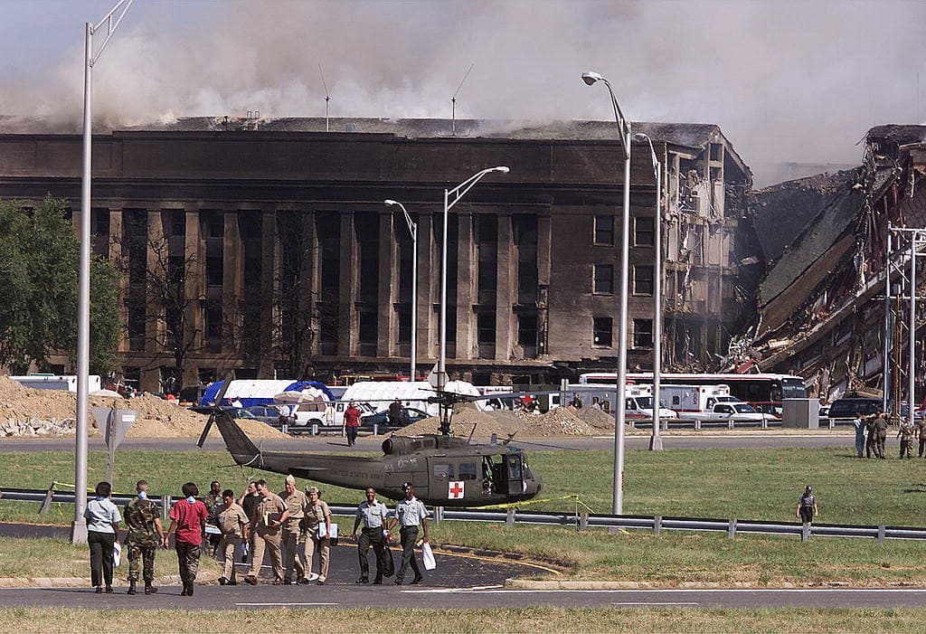Military personnel standing clear of the damaged Pentagon
