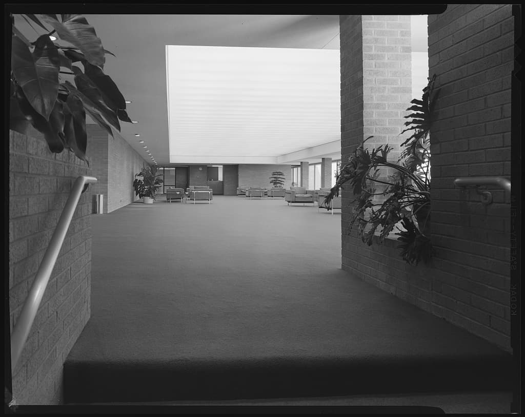 Chairs, warm materials, and clean lines fill the University of Michigan administration center.